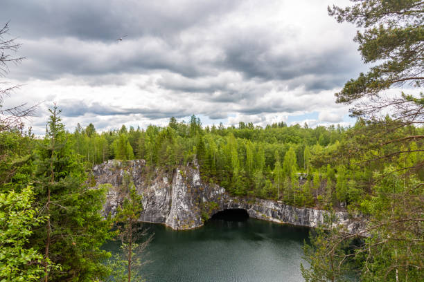 istock Bright Lake is a former quarry where marble was mined under a blue sky with clouds, Karelia. Russia 1135672141