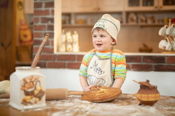 istock Little happy chef in the kitchen. 1135673401