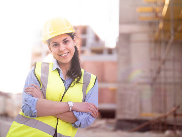 istock Happy young female architect at construction site 1135673402