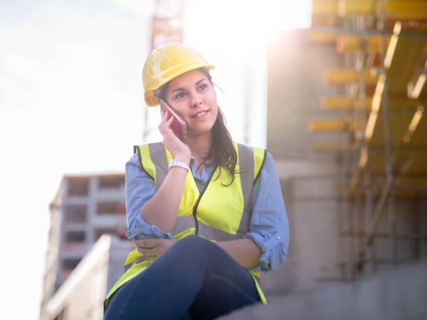 istock Woman manager talking on the phone at construction site. 1135673407