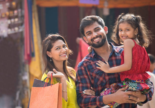 Indian family at street market Happy Indian family at street market happy indian young family couple stock pictures, royalty-free photos & images