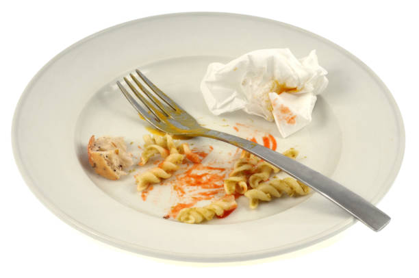 istock Plate with leftover meal on white background 1135678360