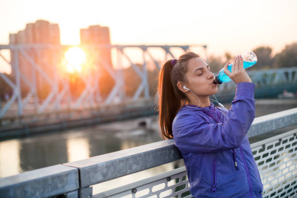 istock Young woman drinking vitamin water 1135678512
