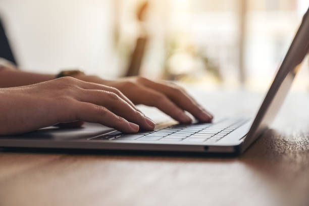 istock woman's hands using and typing on laptop keyboard on the table 1135679319