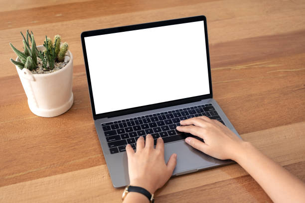 istock a woman using and typing on laptop with blank white desktop screen 1135679364