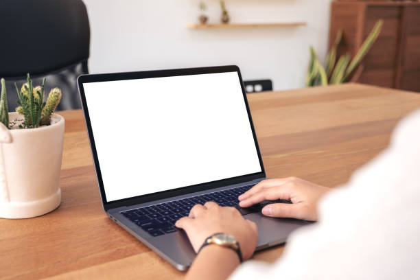istock a woman using and typing on laptop with blank white desktop screen 1135680713