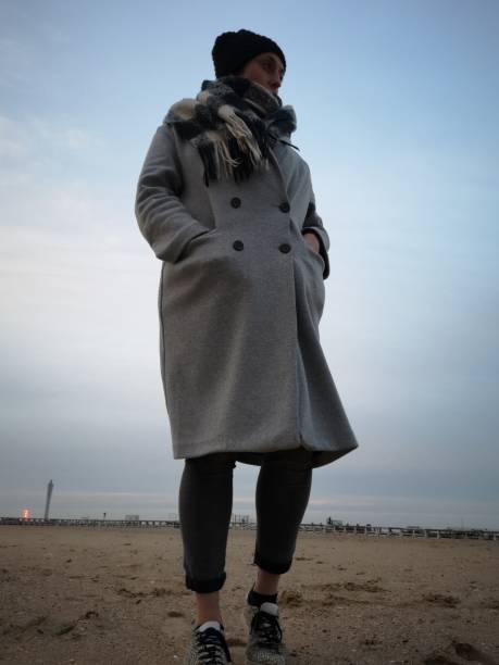 istock lonely woman on an empty beach in winter 1135684188