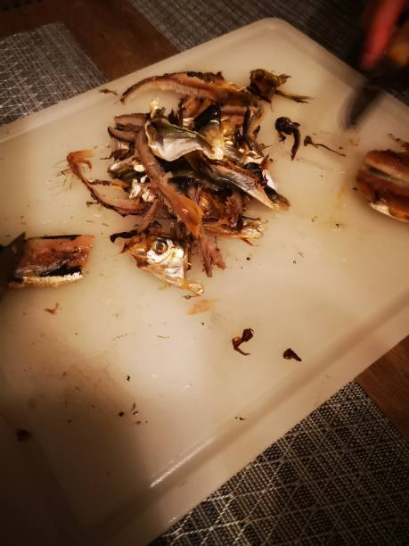 istock filleting smoked sprat, smoked whitebait 1135684293