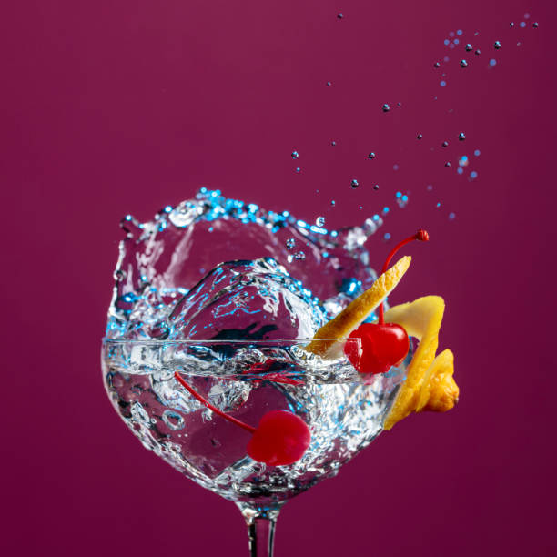 istock Cocktail in glass with splashes garnished with lemon and cherries. 1135685476