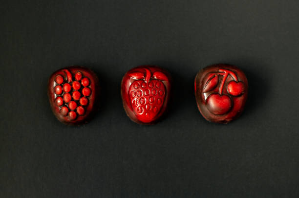 istock Strawberry, grapes and cherry chocolate on black background 1135687608