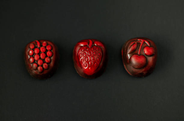 istock Strawberry, grapes and cherry chocolate on black background 1135687804