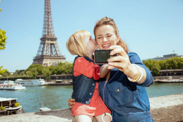 istock mother and child tourists taking selfie with digital camera 1135687849