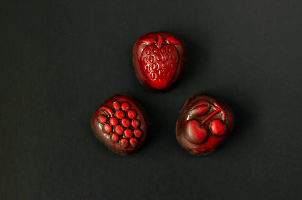 istock Strawberry, grapes and cherry chocolate on black background 1135691874