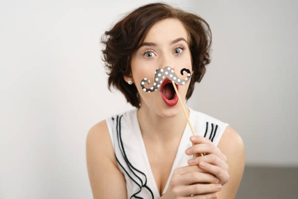 istock Mischievous young woman with a party accessory 1135692915