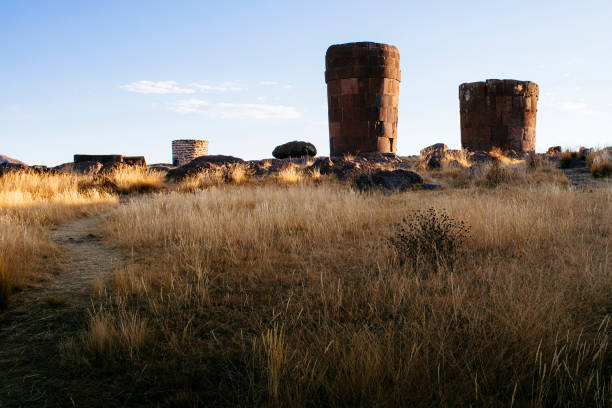 Tourist at the Silustani tombs in the peruvian Andes at Puno Peru