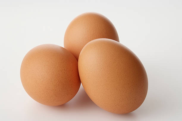 istock Isolated shot of three brown eggs on white background 113569494