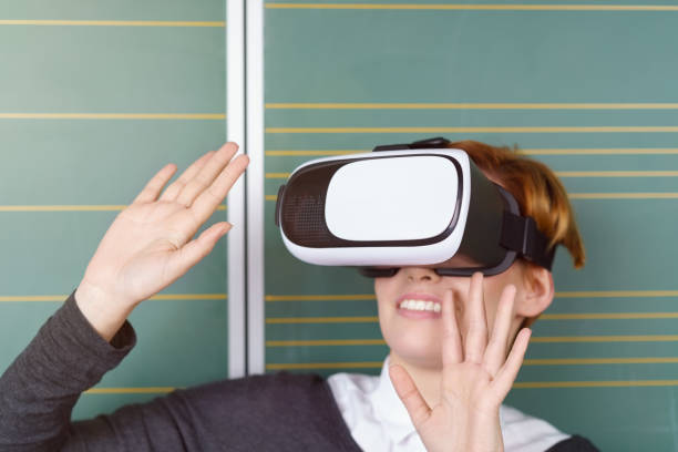 istock Young woman reacting to her VR environment 1135697104