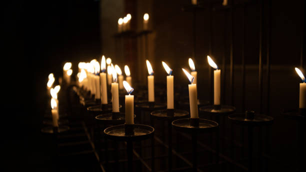 istock Candles in the dark church. 1135697118