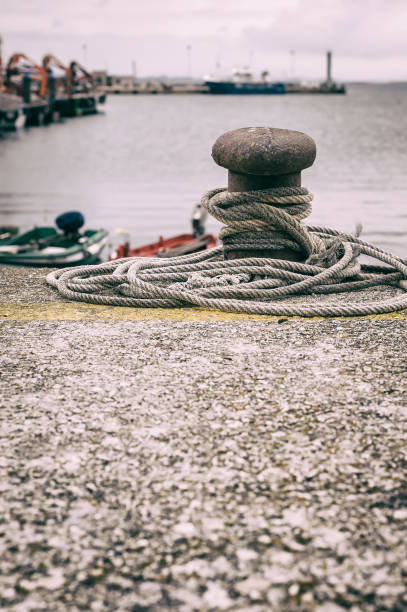 istock Old Mooring Bollard with rope tied 1135697209