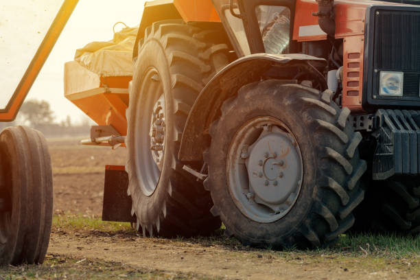 istock Old red agricultural tractor with trailer 1135697474