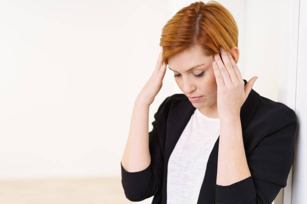 istock Young stressed businesswoman with a headache 1135697527