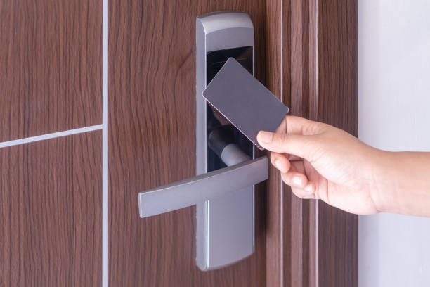istock Hand using electronic smart contactless key card for unlock door in hotel or house. 1135697594