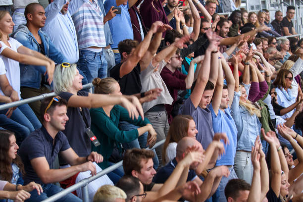 Mexican wave on stadium People doing the mexican wave on the sport or music event. doing the wave stock pictures, royalty-free photos & images