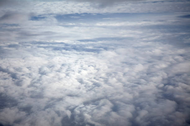 istock flying high in the sky, with sunshine, blue sky and white clouds 1135703106