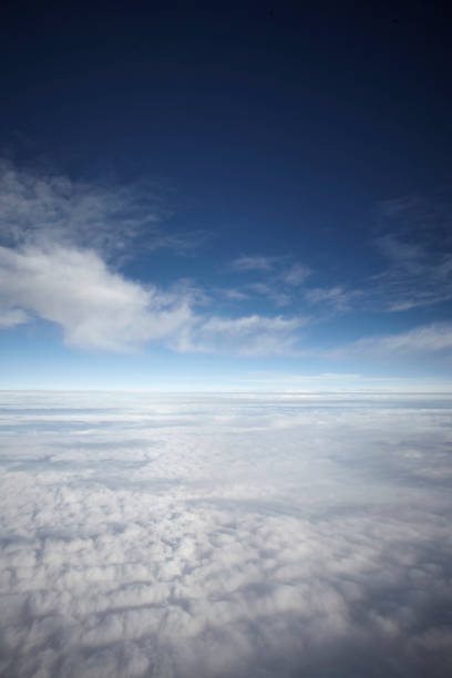 istock flying high in the sky, with sunshine, blue sky and white clouds 1135703113