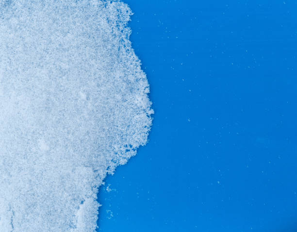 istock White snowy fields under a blue background. Snow texture Top view of the snow. 1135703116