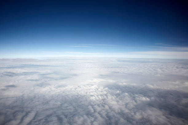 istock flying high in the sky, with sunshine, blue sky and white clouds 1135703119