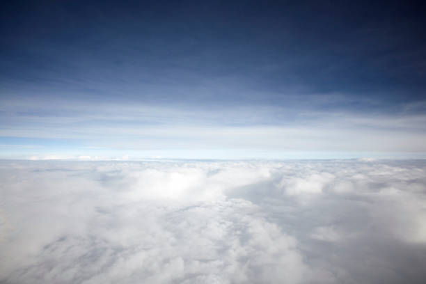 istock flying high in the sky, with sunshine, blue sky and white clouds 1135703144