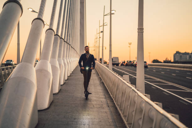 istock Businessman riding scooter at evening 1135709239