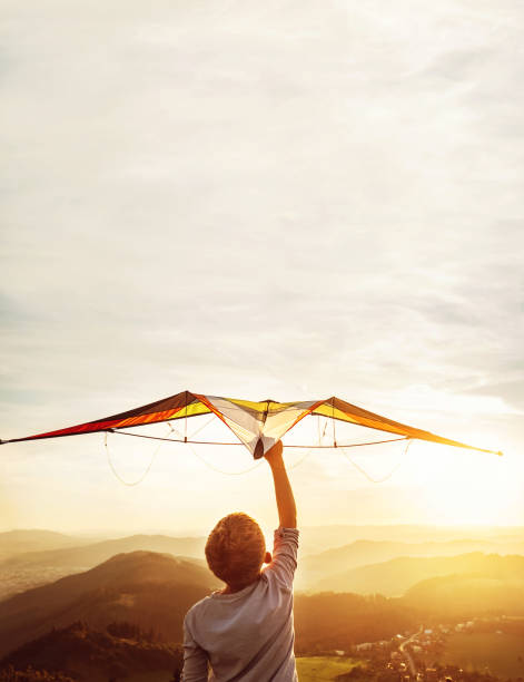 istock In dreams about flying. Boy takes a kite over his head 1135709518