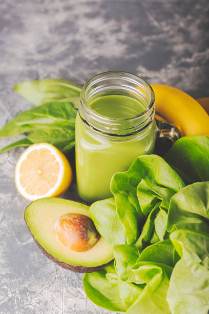 istock Green smoothie in moody dark background 1135709960