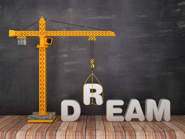 istock Tower Crane with DREAM Word on Chalkboard Background - 3D Rendering 1135710787