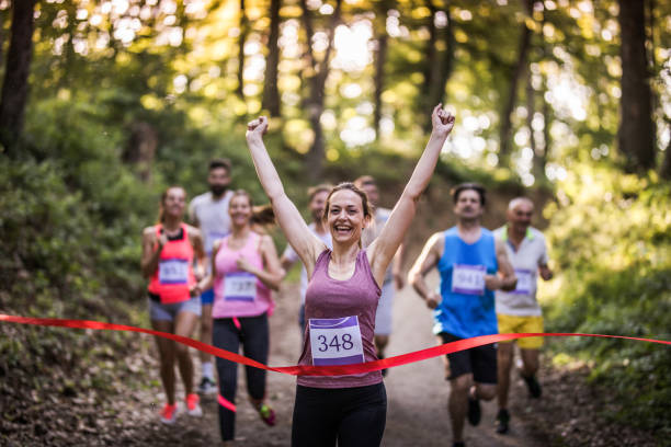 istock Successful marathon runner winning a race and crossing the finish line. 1135711013