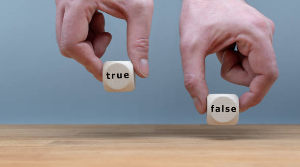 istock True or False? Two Hands hold two dice with the words 