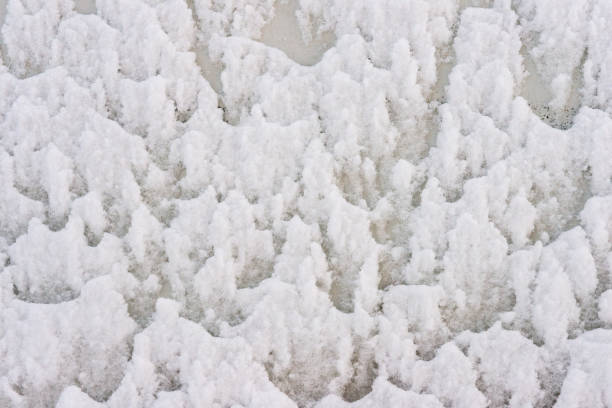 This photograph is a detail of snow covering a metal door in Denver, Colorado, USA.