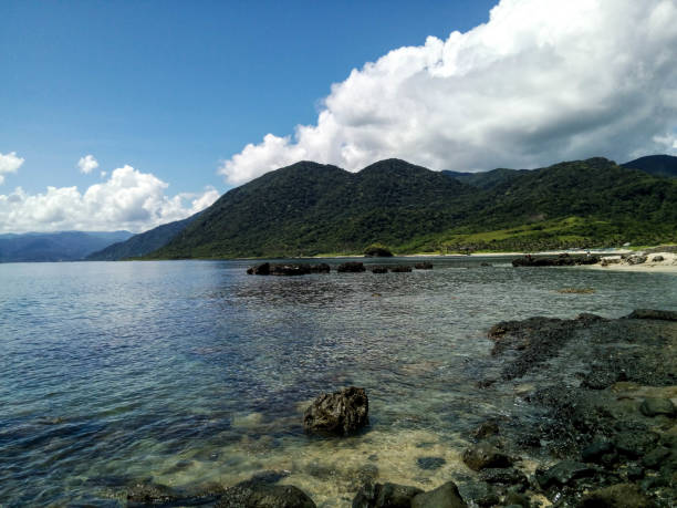 istock Green hills beside the blue ocean 1135712245
