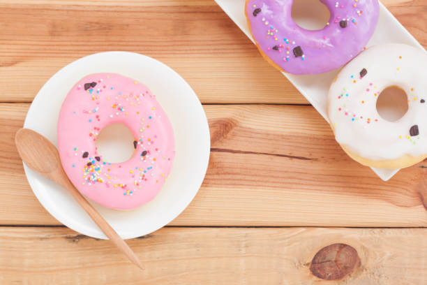 istock Sweet donuts on wooden background. 1135712648
