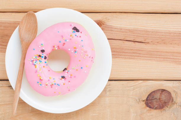 Sweet donuts on wooden background.
