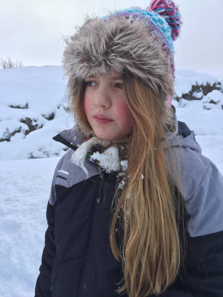 istock Contemplating girl with snow on her clotes 1135712713