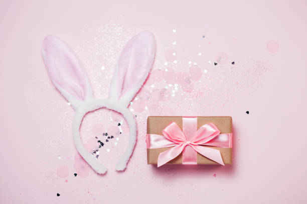 istock Top view and flat lay of Easter symbol - bunny ears on pink background. 1135713429