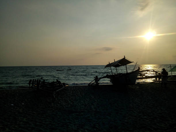 istock Boat in the sunset by the sea 1135713635