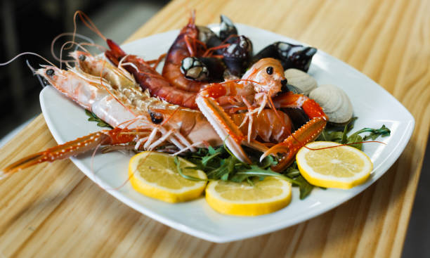 istock Prawns, langoustines and clams on white plate 1135715636