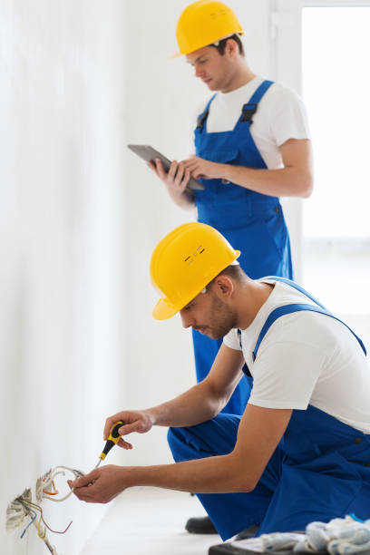 istock builders with tablet pc and fixing wiring indoors 1135716909