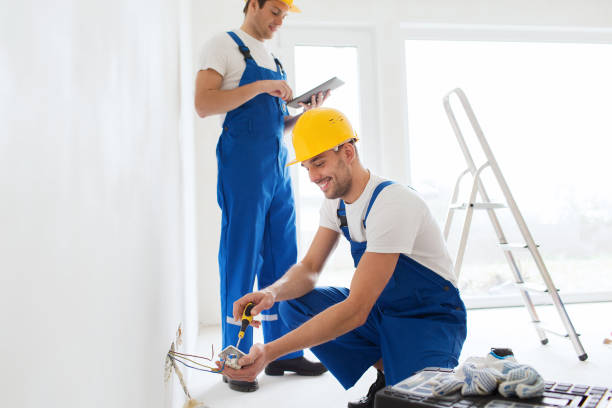 istock builders with tablet pc and fixing wiring indoors 1135717112