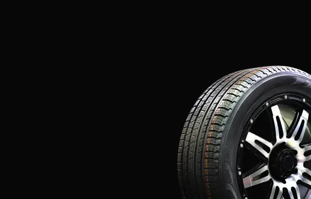 Car Wheel Rubber with Alloy Rim Isolated on Black Background,copy space