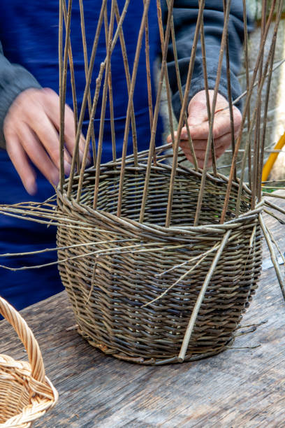 istock Vannier in the process of making a wicker basket 1135718142